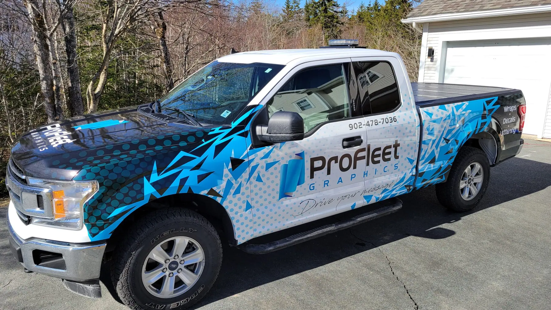 ProFleet Graphics wrapped Ford F-150 pickup in blue geometric vinyl, parked in Nova Scotia
