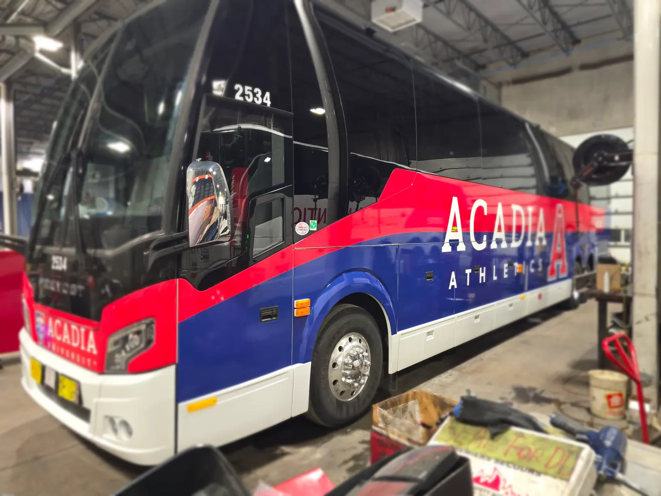 Acadia University Athletics motorcoach wrap in red, white and blue