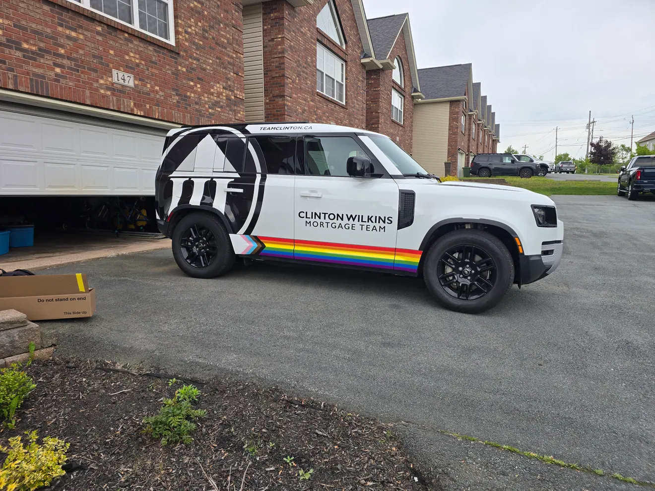 Clinton Wilkins Mortgage Team graphics on a Land Rover Defender
