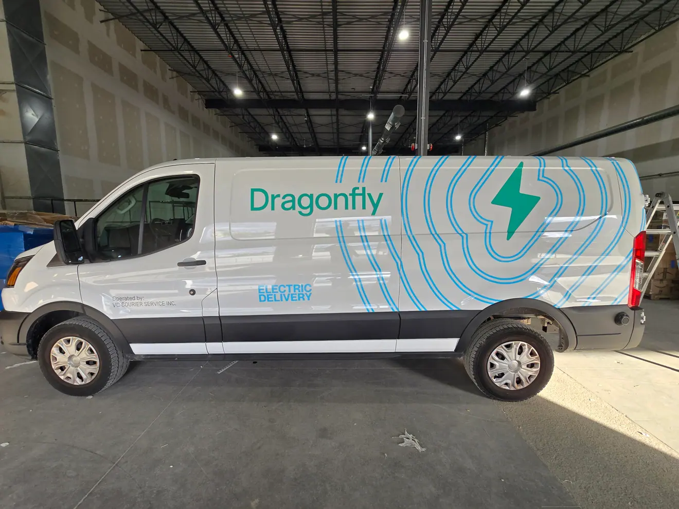 Dragonfly delivery van wrapped in green and white brand graphics