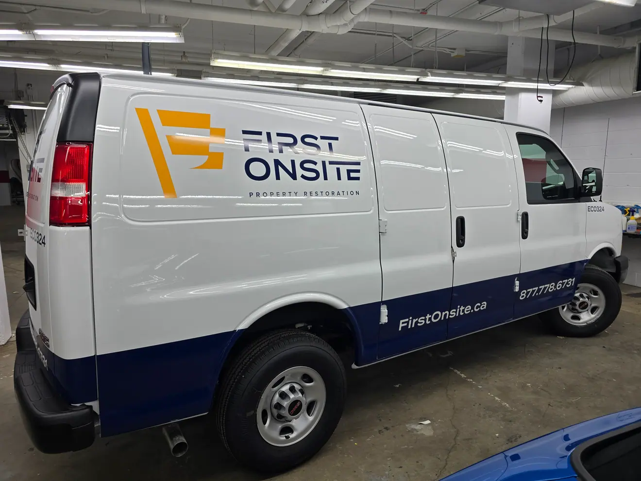 First Onsite Property Restoration graphics on a GMC Savana cargo van