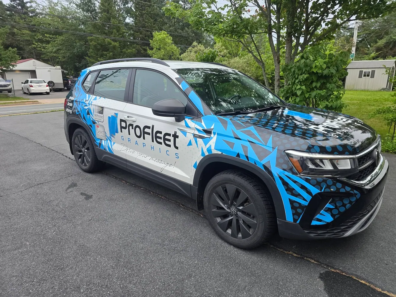 The ProFleet Graphics shop vehicle wrapped in the company’s own blue graphics and “Drive your message!” slogan
