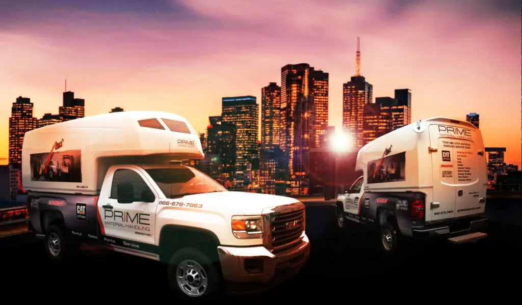 Fleet of wrapped service trucks for Prime Material Handling against a city skyline