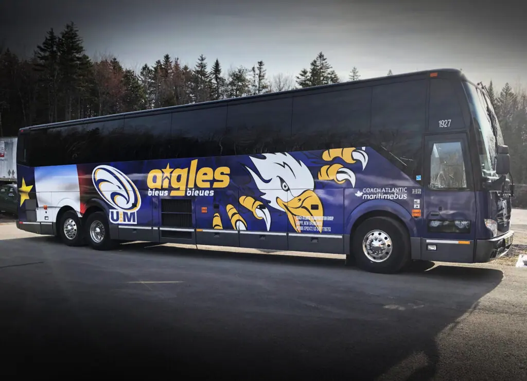 Full-length printed wrap on a coach operated by Université de Moncton, installed by ProFleet Graphics